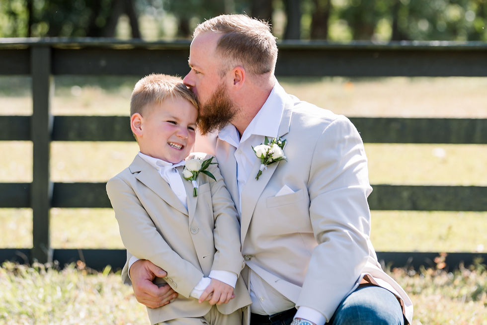 Man giving boy a kiss on the forehead