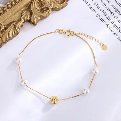 थंबनेल: Elegante pulsera de NINE'S en oro sólido de 18 quilates con perlas naturales.