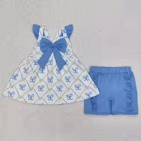 Preciosos veraniegos para niñas: blusa con lazos azules y shorts con volantes.