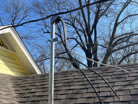 An installed weather head in Paris, TX on top of a roof