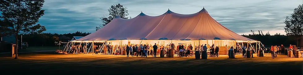 wedding reception under a sailcloth tent rental during sunset