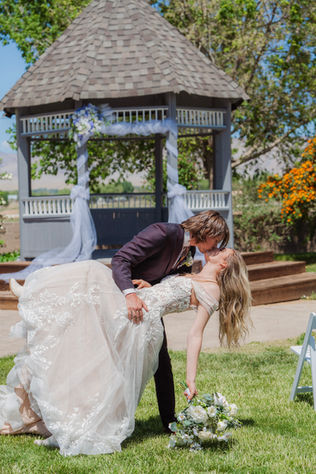 Groom and Bride in front of gazebo in Grand Junction wedding.