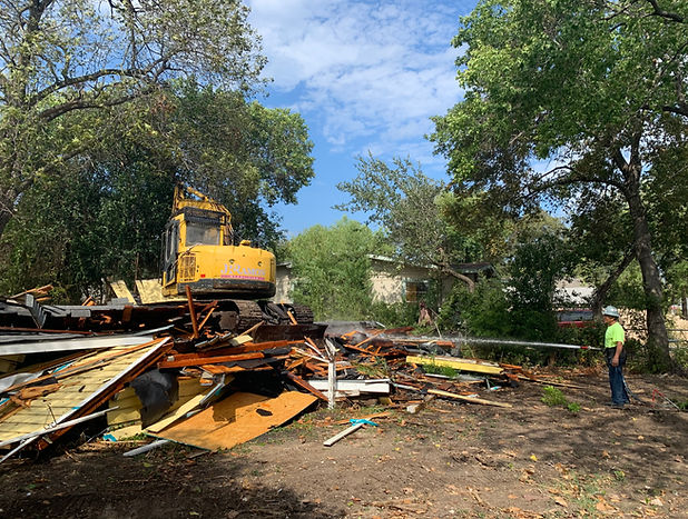 A man at a residental demolition site.