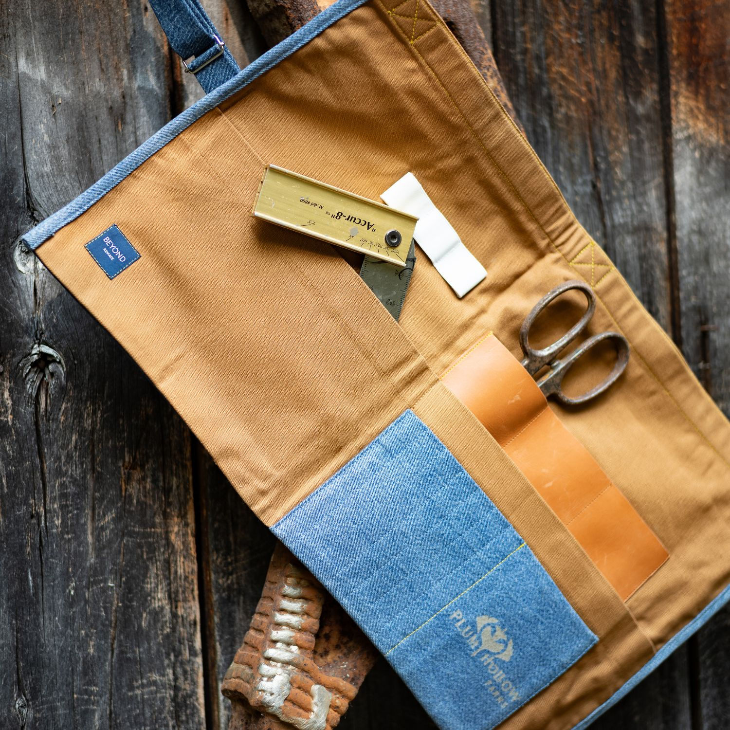 Upcycled garden tool roll made from reclaimed canvas and denim with pockets for gardening tools, handcrafted by Plum Hollow F