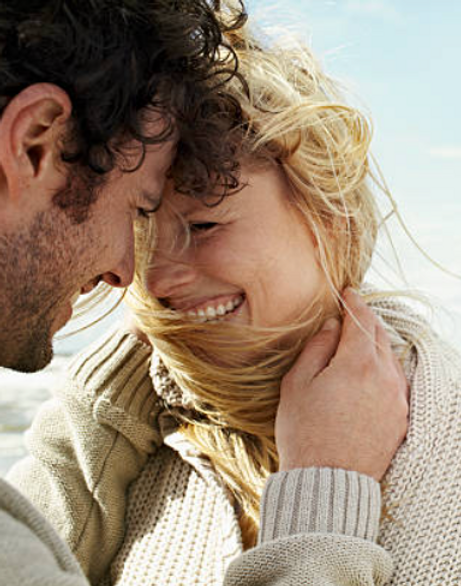 couple smiling man touching woman's face