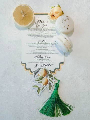 Die-cut menu with lemon illustration and tassel, styled with citrus and macarons.