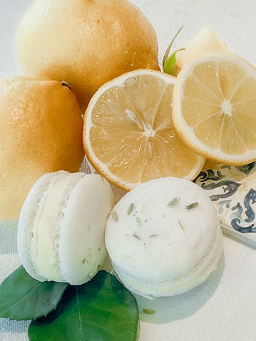Artisan lemon and lavender macarons with fresh lemons for a citrus and coastal feel.