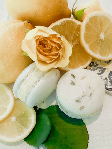 Artisan lemon and lavender macarons with fresh lemons for a citrus and coastal feel.