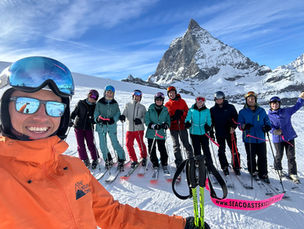 many people standing in a line in front of The Matterhorn