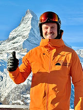 A Zermatt ski guide showing a thumbs up with the Matterhorn behind