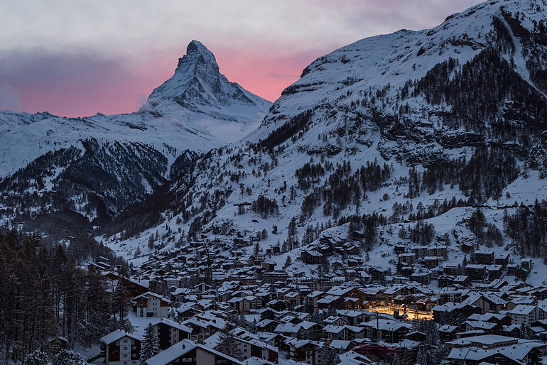 zermatt at sunset with a pink sky and the Matterhorn looking wonderus