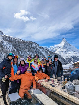 a photo is taken of a group of people with the matterhorn behind