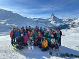 a large group of people are gathered together on a ski holiday