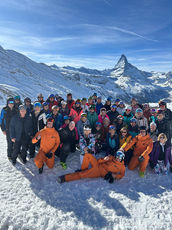 a large group of people with some ski guides are taking a shot for the camera 