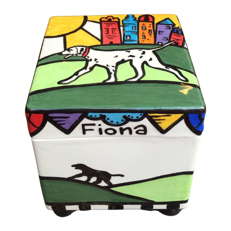 Thumbnail: White spotted dog walking on grass, with city skyline and bunting above name Fiona – hand-painted urn box