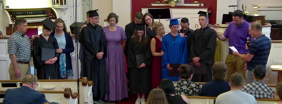 Rick Stacy prays for the Graduates