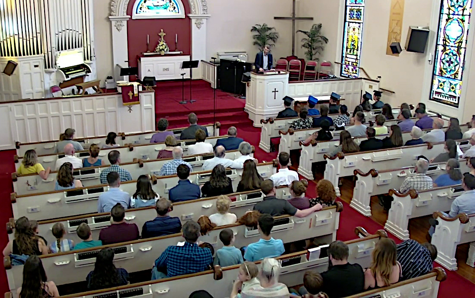 Tanner Neufeld, YWAM, speaks to the graduates