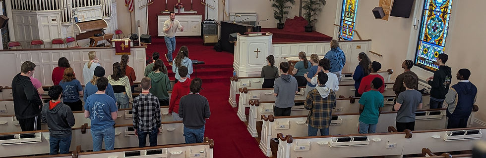 Dr. Adam Potter leads the Chorale in voice exercises on Saturday