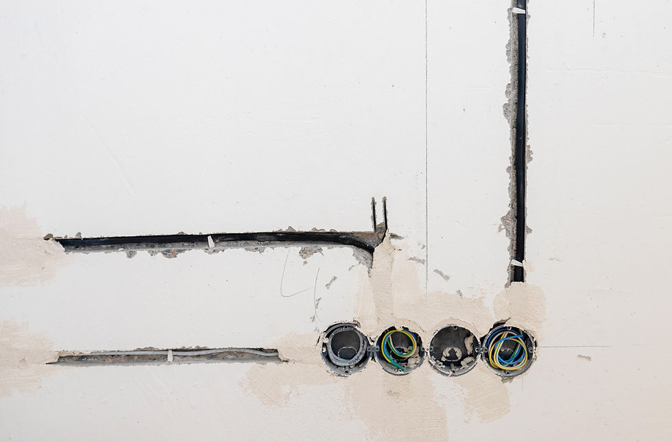 Electrical work with rough finish, electrician connects and mounts copper wires for outlet