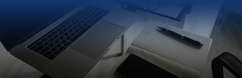 Desktop with phone and laptop and notebook