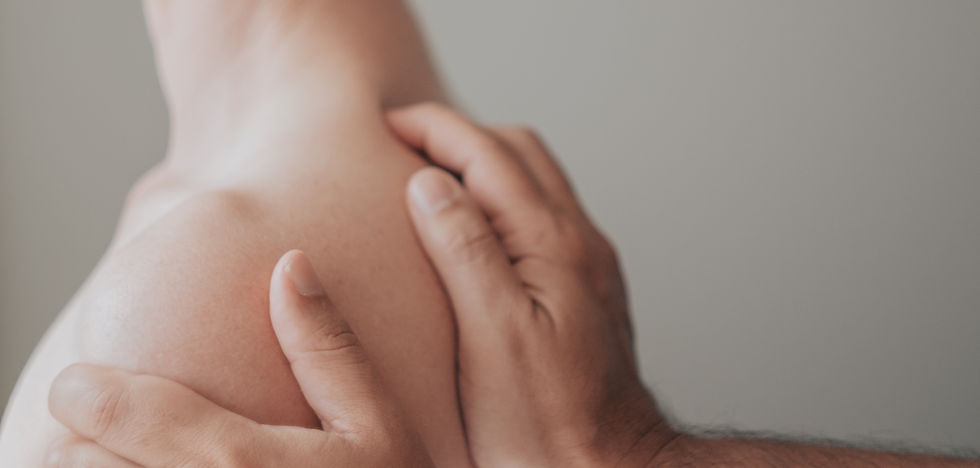 Close-up view of a massage therapist’s hands gently working on a client’s back