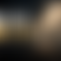 Person standing in darkness as a beam of light shines down, symbolizing God’s unconditional love and grace.