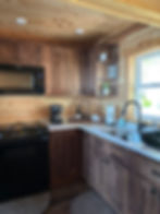 Kitchen in a custom log home with wood walls and cabinets