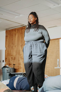 Andrea Joy Pearson walking through a group during a restorative sound healing session at CIRA.