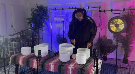Andrea Joy Pearson playing crystal singing bowls during her debut Journey of Becoming performance for Gongs Unlimited.