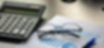 Glasses and calculator on financial report