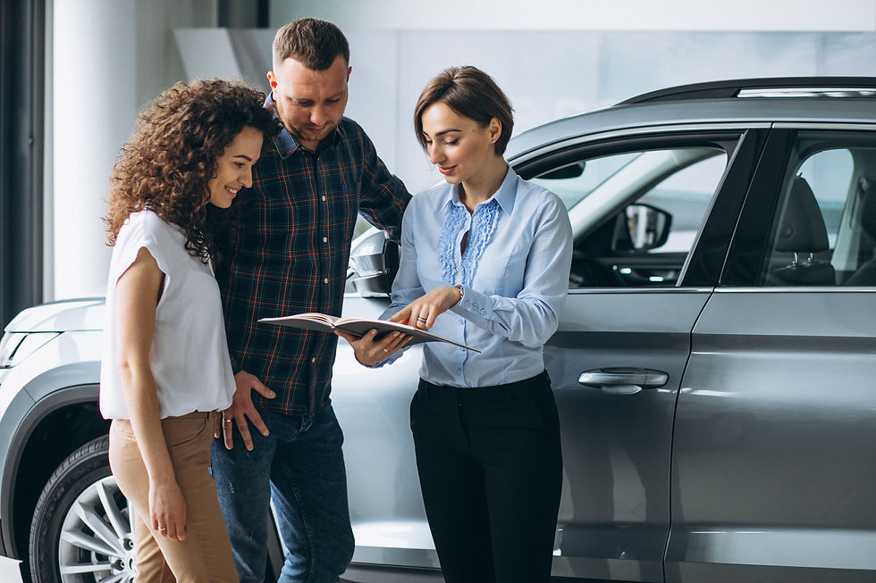 young-couple-talking-sales-person-car-showroom (2).jpg