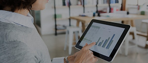 Woman Checking Data on Tablet