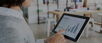 Woman Checking Data on Tablet