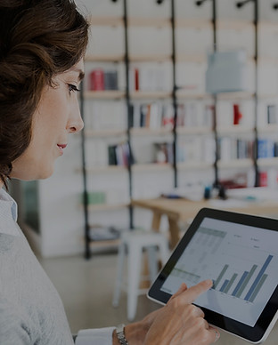 Woman Checking Data on Tablet