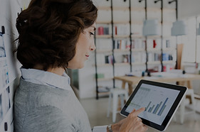 Woman Checking Data on Tablet