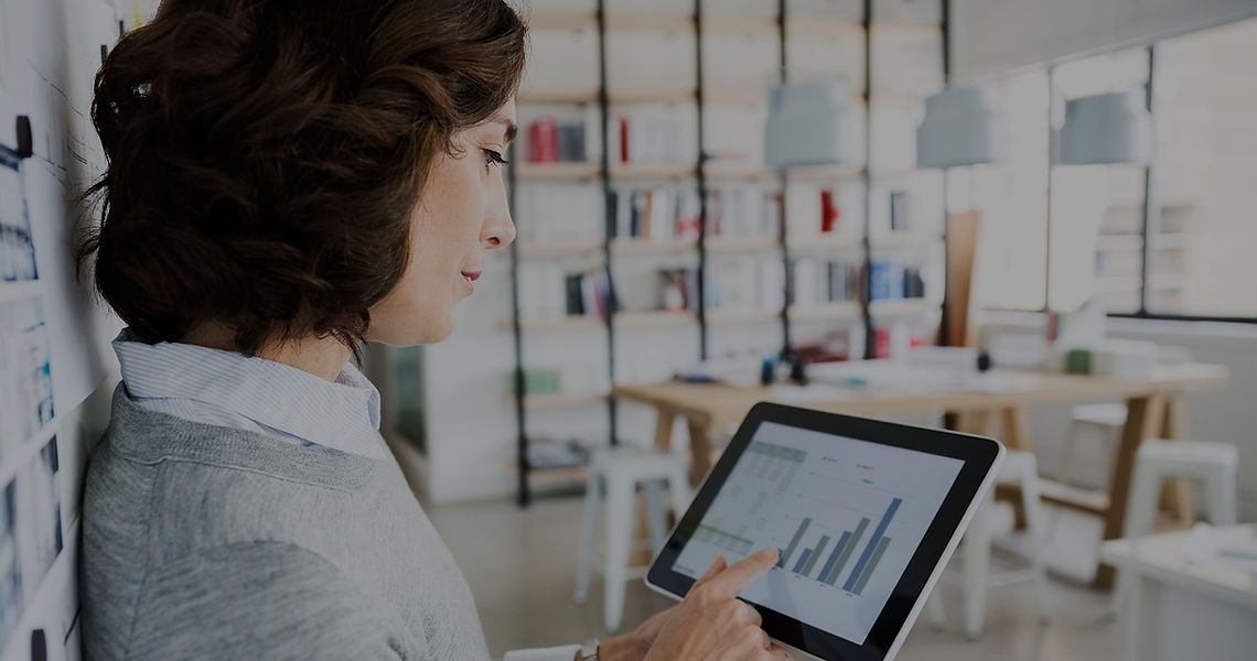 Woman Checking Data on Tablet
