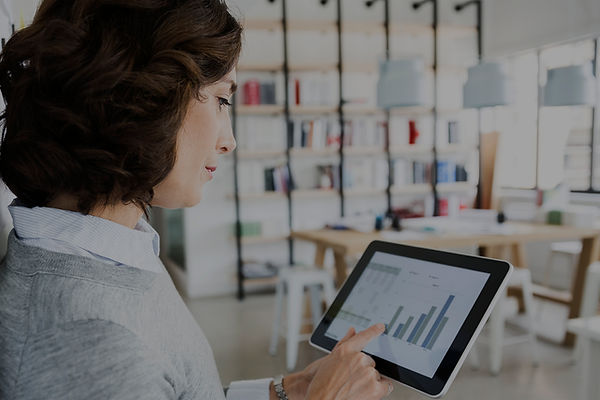 Woman Checking Data on Tablet