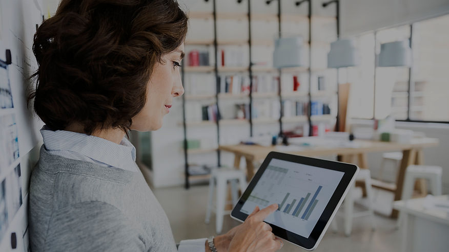 Woman Checking Data on Tablet