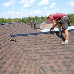 Roofer installing shingles on a roof