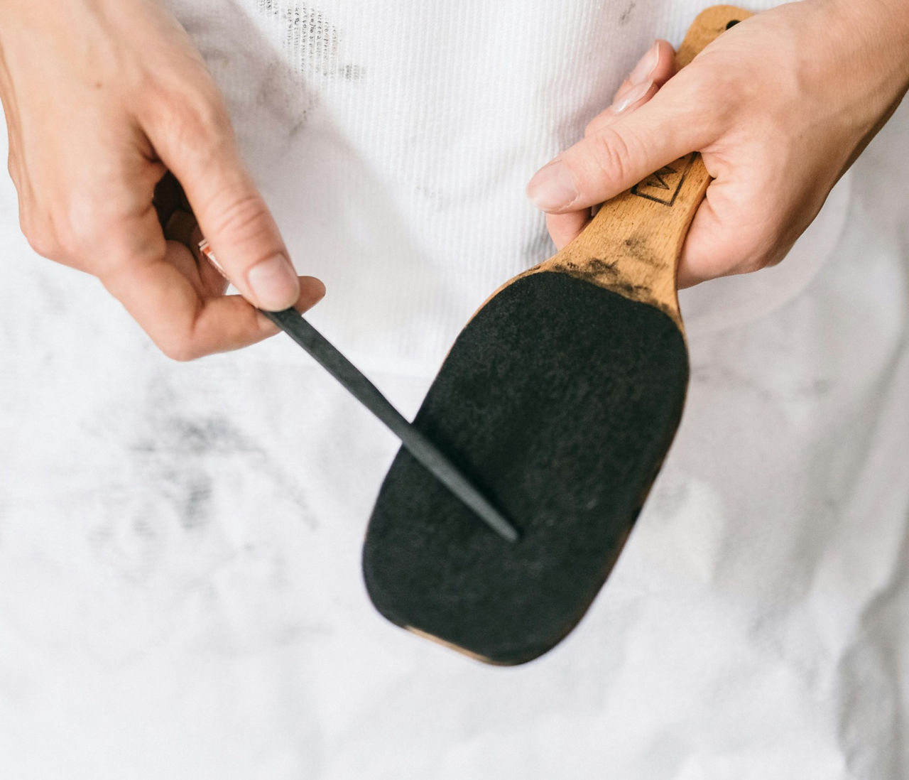  Crafting precision with care: Sharpening a pencil with sandpaper for a customized point.