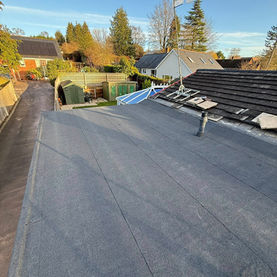 Spacious flat roof renovation project with modern waterproof covering and open surroundings.