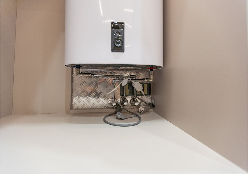 View of a utility room ceiling showing black insulated pipes, a gray tank, and a red pressure tank