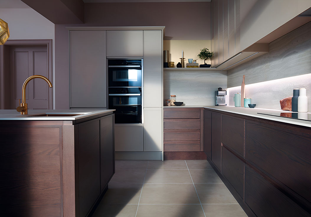 Modern kitchen featuring dark wood cabinetry, brass fixtures, and ambient lighting