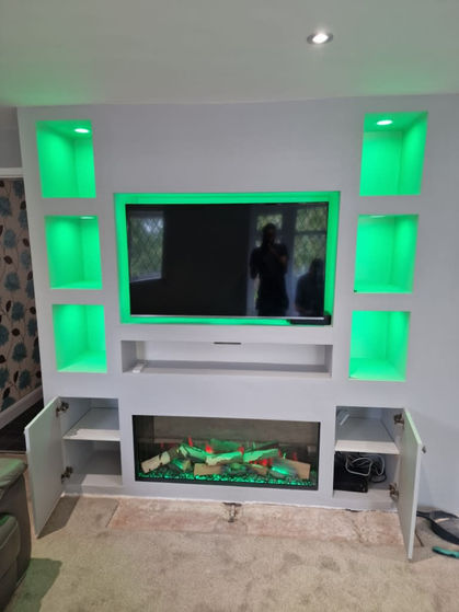 LED-lit media wall with colour-changing lighting and electric fireplace.