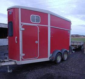 Red horsebox trailer maintained and serviced for safe transport journeys.