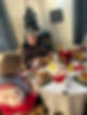 A festive Christmas meal with three people around a table, decorated with a poinsettia and drinks