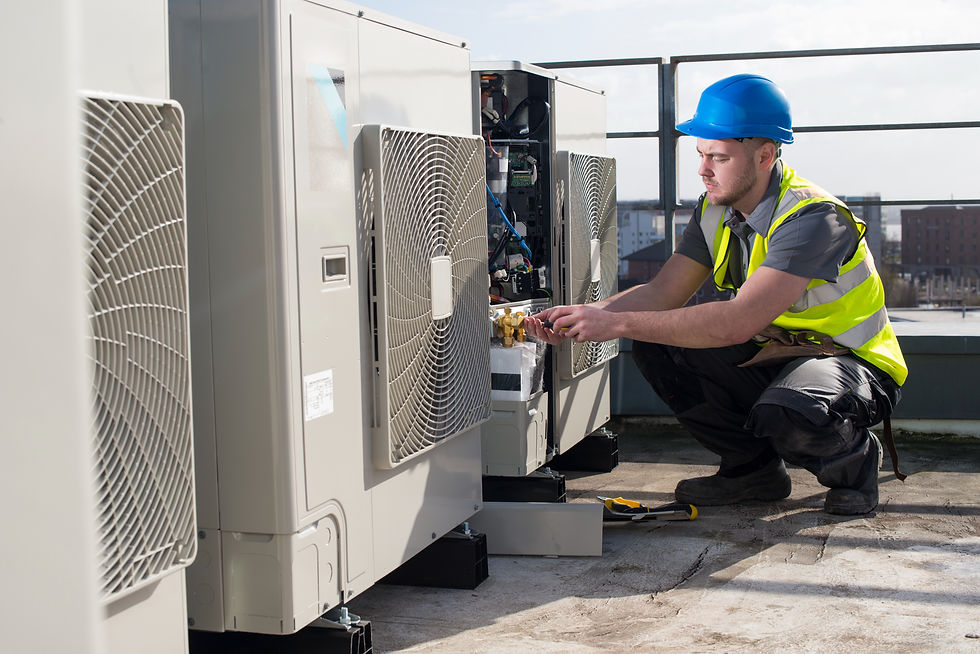 HVAC technician servicing rooftop air conditioning units for commercial building maintenance.