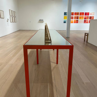 Modern gallery interior featuring minimalist furniture and contemporary artwork displays.