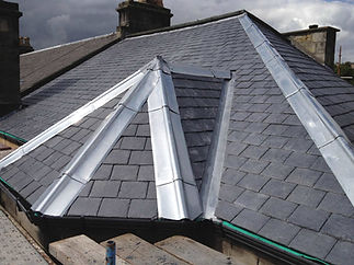 Slate roof with metal valley flashing during a roofing installation