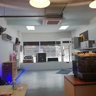 Commercial air conditioning showroom displaying HVAC systems and ceiling cassette unit